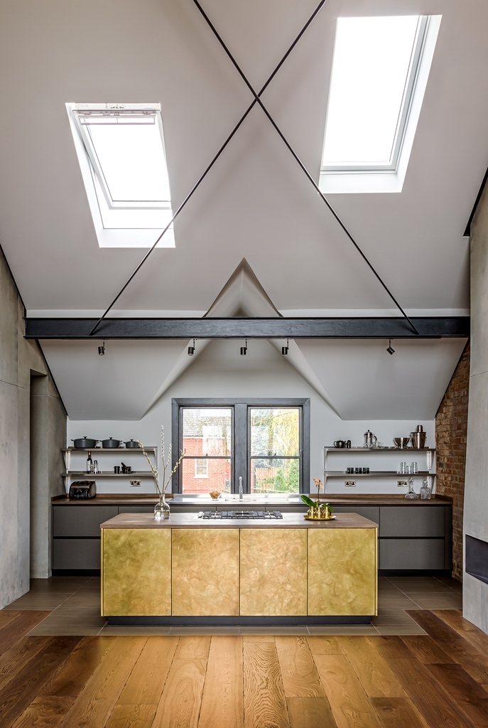 Soaring ceilings, concrete walls, and steel beams create the perfect focal point for a statement kitchen island clad in burnished brass making this a winning scheme! #brasskitchens #bespokekitchens #luxurykitchens l8r.it/x7JX