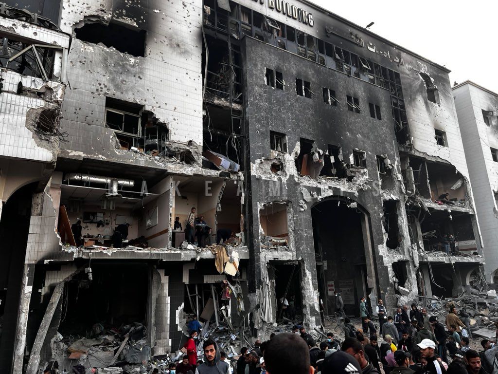 DrMadsGilbert's tweet photo. Today, we witness the total ISraeli destruction of the most important, 700 beds specialty hospital in Gaza, Al Shifa Medical Complex. It was established 78 years ago during the British Mandate, the name Shifa meaning 'The House of Healing'; now turned into a 'House of Death' by Israel and the US, burnt, totally destroyed to rubble and turned into a graveyard of patients, medical staff, relatives and refugees. A massive symbol of the heartless, cynical ISraeli politics of colonial occupation with the goal of elimination of the Palestinian people, their social institutions and their lives. US, EU, UK governments stand shamed, complicit by their support for ISraeli war crimes and atrocities against all humanity. Watch carefully the killing fields of Shifa, never ever forget the Gaza genocide, the perpetrators, and the complicit powers! Dr. Mads