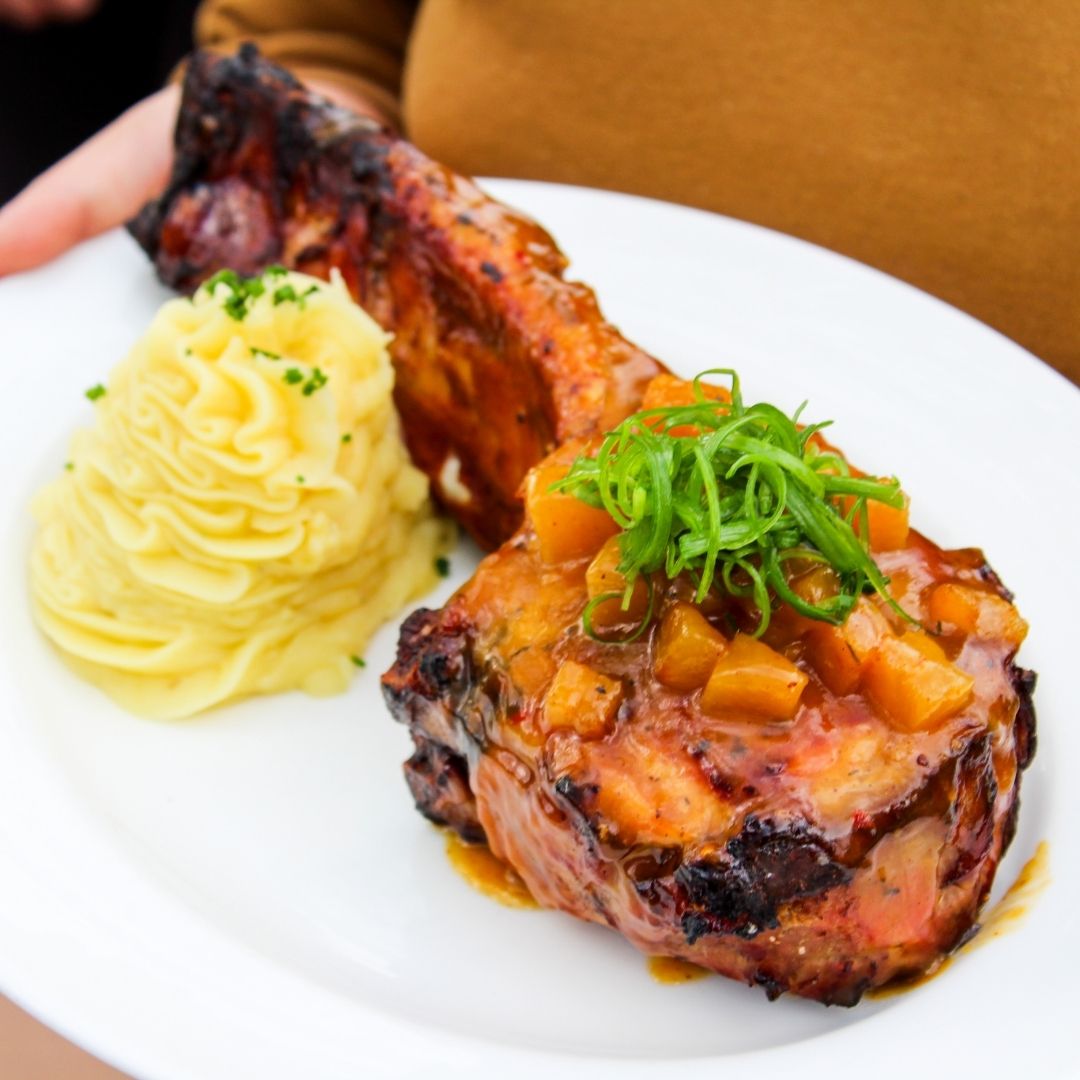 Sophistication on a plate. Winewood’s double-bone, in-house, smoked Tomahawk Pork Chop is delicately glazed with a luxurious pineapple-bourbon sauce &amp; accompanied by garlic mashed potatoes.

#WinewoodGrill #Winewood #Grapevine #DFW #Spring #PatioSeason #PorkChop #Steakhouse