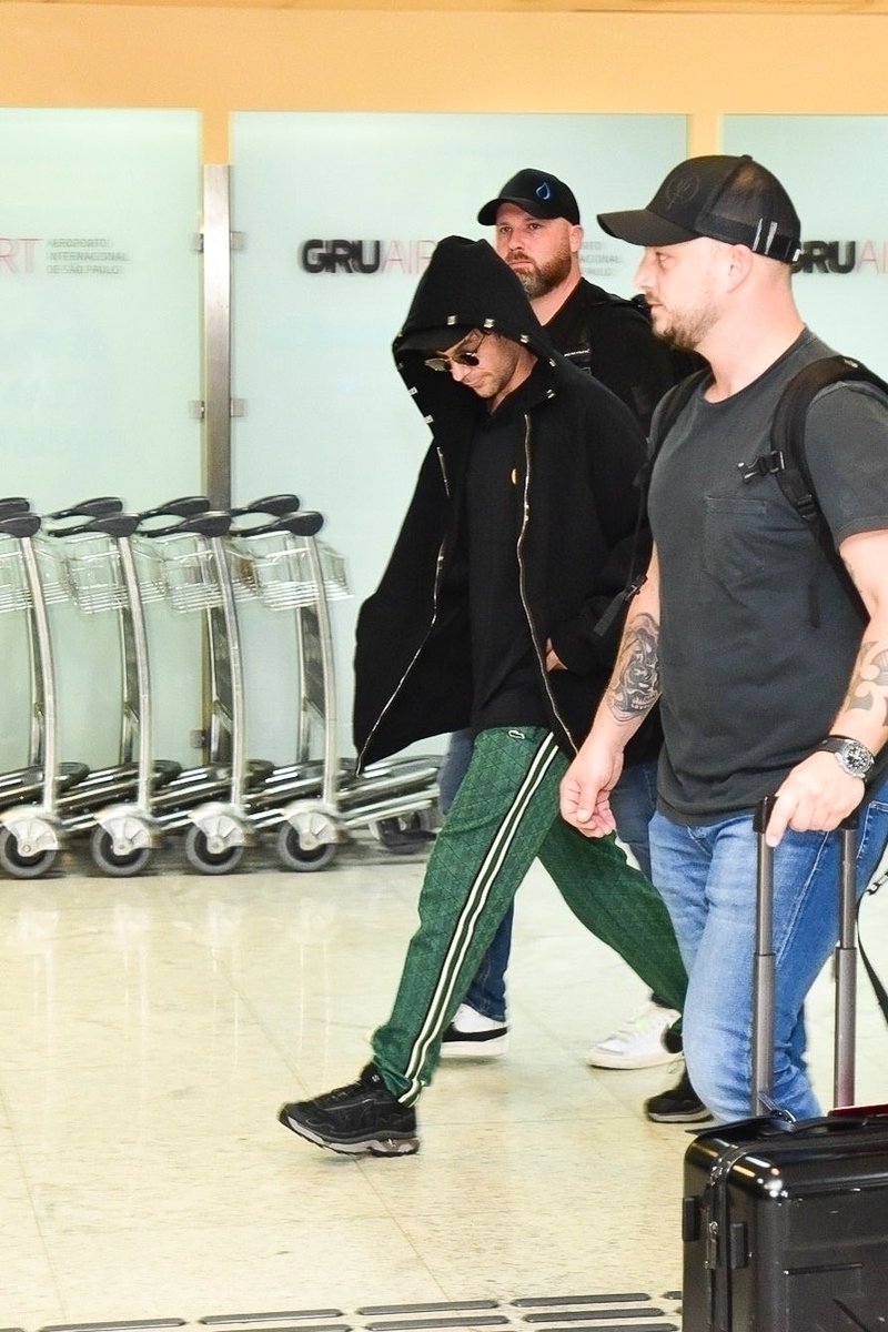 Louis walking out of the airport earlier today in Brazil.