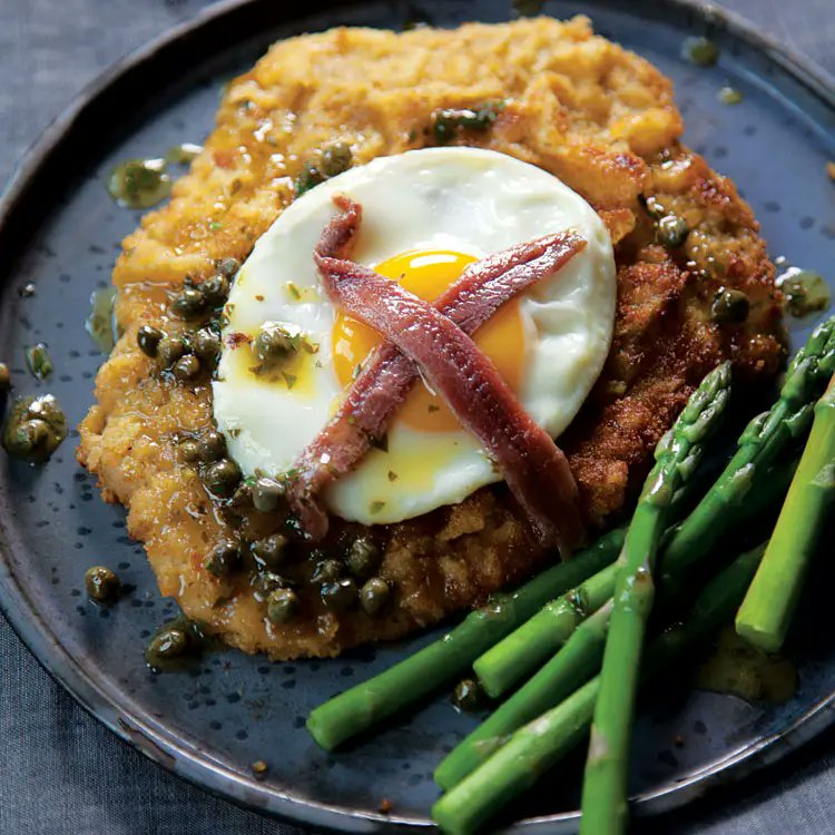 Schnitzel à la Holstein is a German dish of breaded veal cutlets with fried egg, anchovies, and lemon-caper Sauce.

Would you try it?
