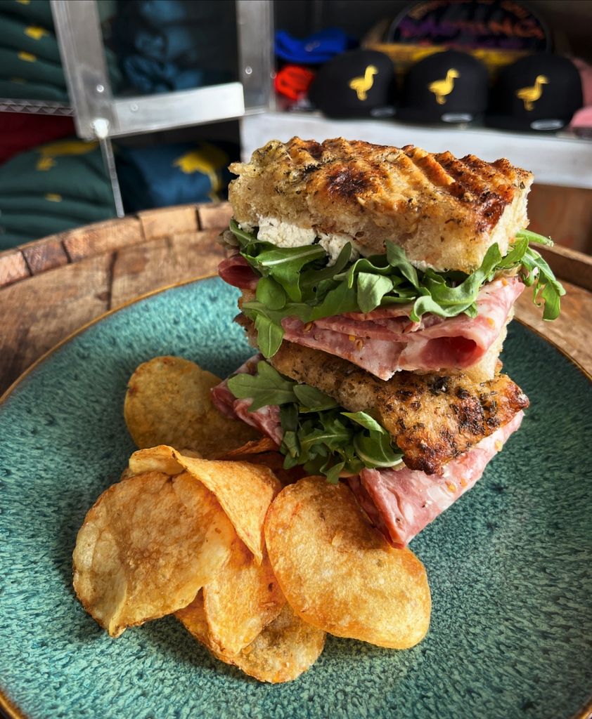 our Salame Cotto sitting pretty in our #SandwichOfTheWeek with Tulip Tree Creamery's Fromage Frais, shaved pickled brussels sprouts, arugula, Amelia's Focaccia, Broad Ripple Chips Walk-in Mon-Sat 411 Dorman St #Indy free parking lot Delivery/Catering: publicsmokehousecatering.square.site