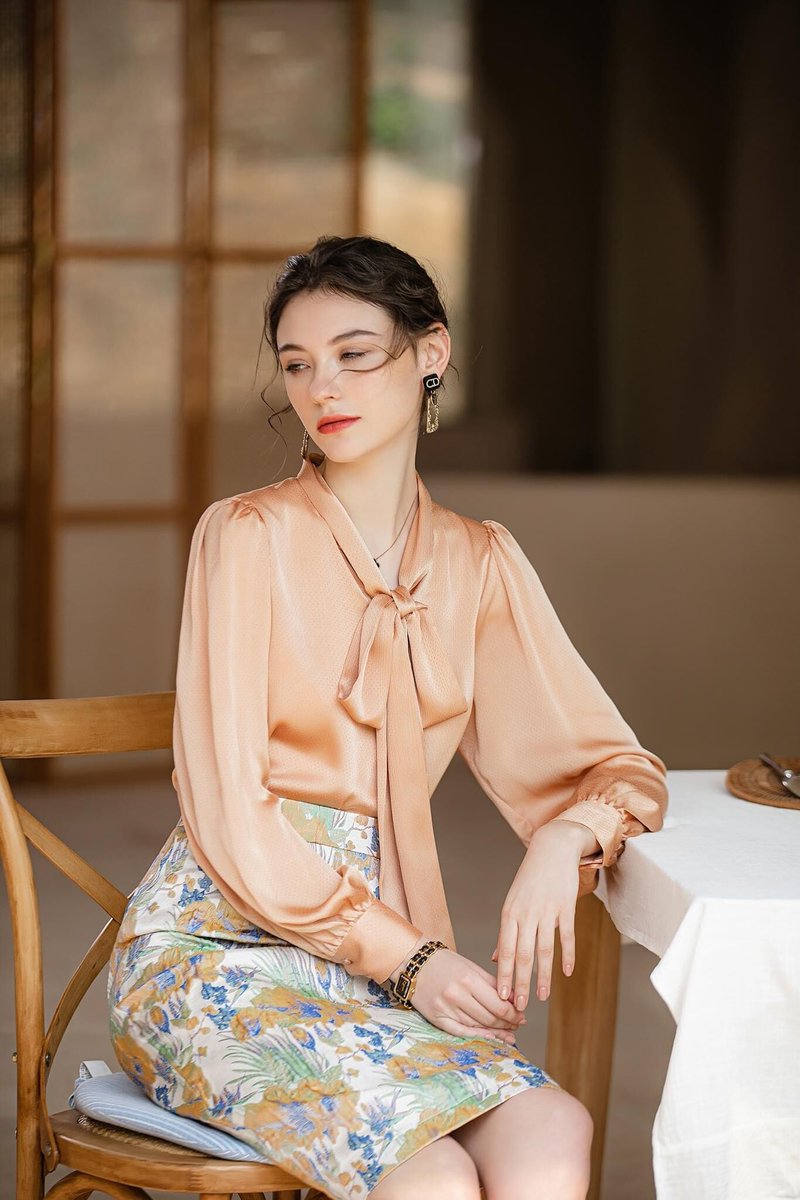 Dress for success AND sophistication with our newest collection. 🌼👩‍💼 The Apricot Bow-Tie Blouse & Botanical Skirt is your new workday staple! #FashionByTeresa #ProfessionalStyle #FashionForward #WorkplaceChic