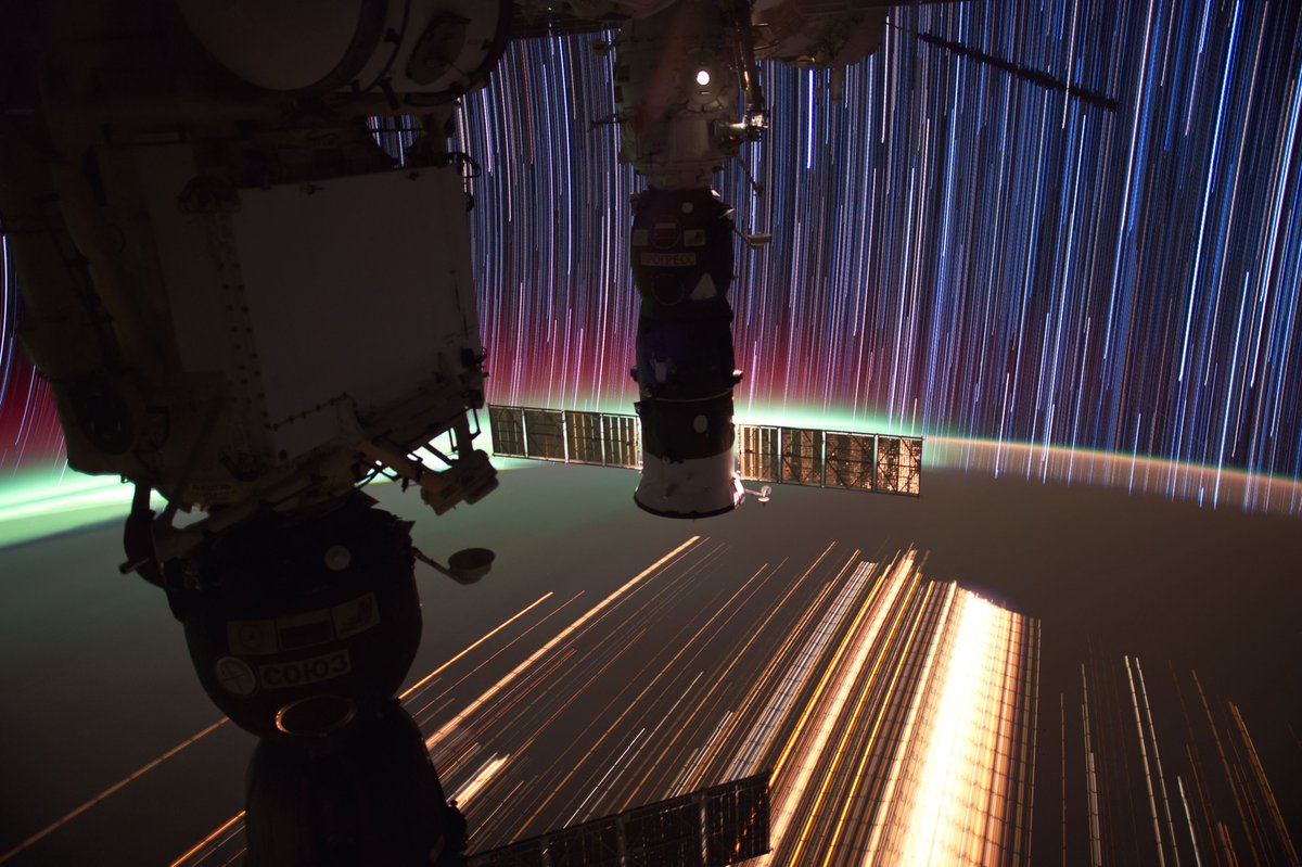 One of my time exposures from @Space_Station, demonstrating how orbital astrophotography reveals phenomena viewed from space as a function of time. Here our Soyuz and Progress cargo vehicle cuts through the exposure, forming star trails as straight lines, city streaks across the