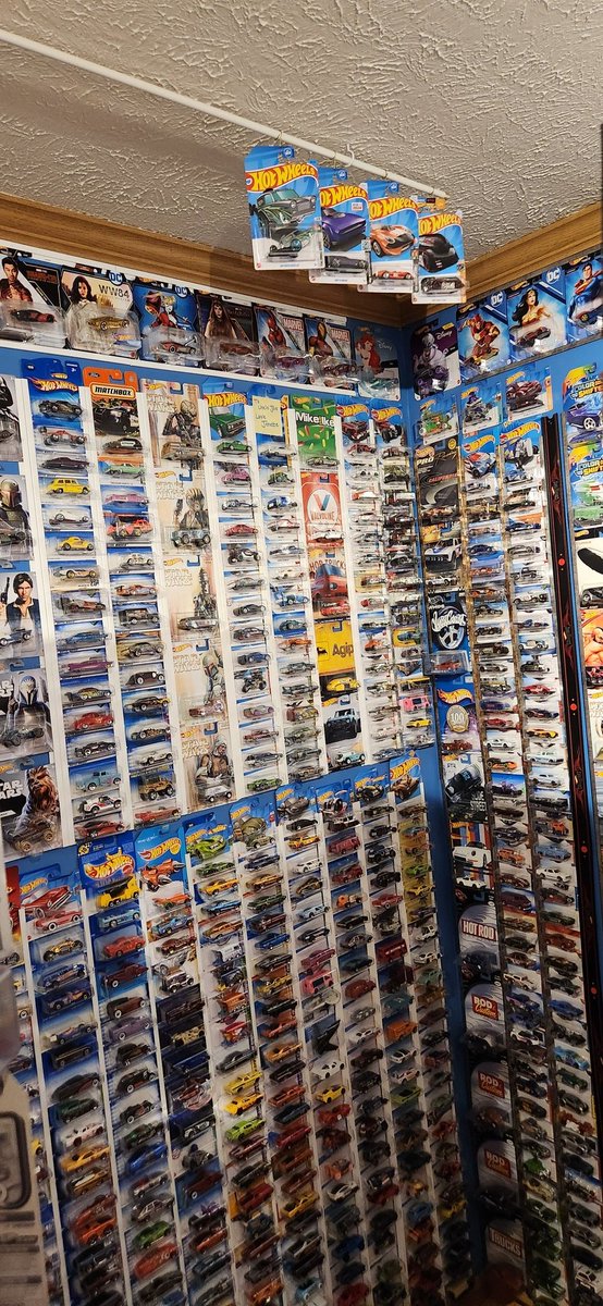 I finally decided to use a curtain rod!!! So much ceiling!! So many more to display!!! #HotWheels #diecast #toycollector #minimuseum