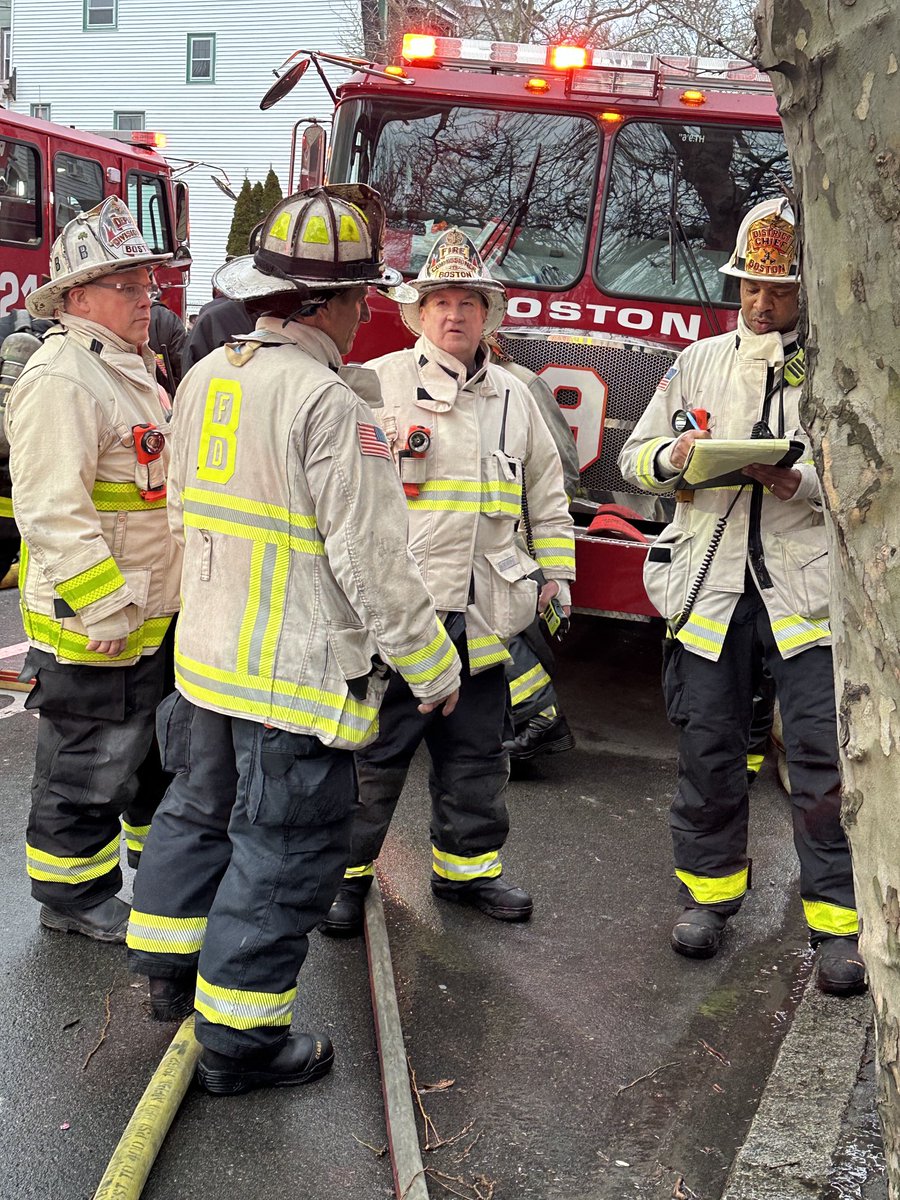 Fire Commissioner Paul Burke consults with his Command staff , at the 6 alarm fire in East Boston