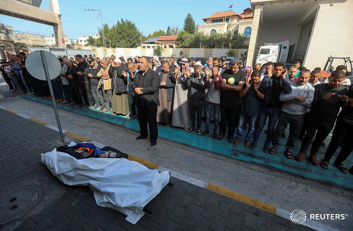 Mourners offer funeral prayers next to the body of Palestinian Issam Abu Taha, a worker from the World Central Kitchen, who was killed in an Israeli airstrike along with other workers, according to the NGO, in the Gaza Strip April 2,2024. REUTERS/Ahmed Zakot