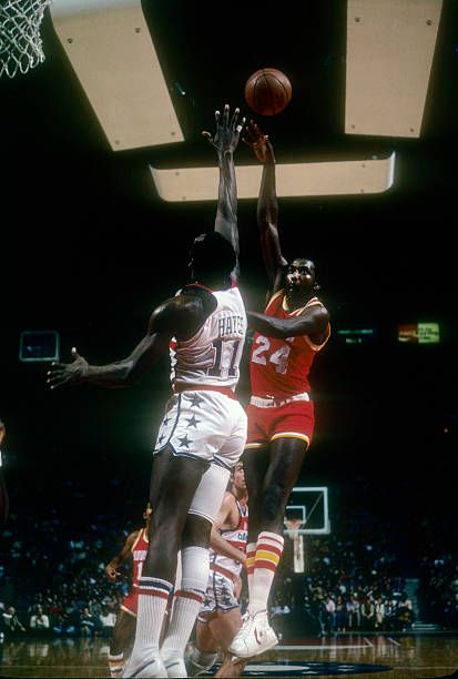 Moses Malone shooting over Elvin Hayes.