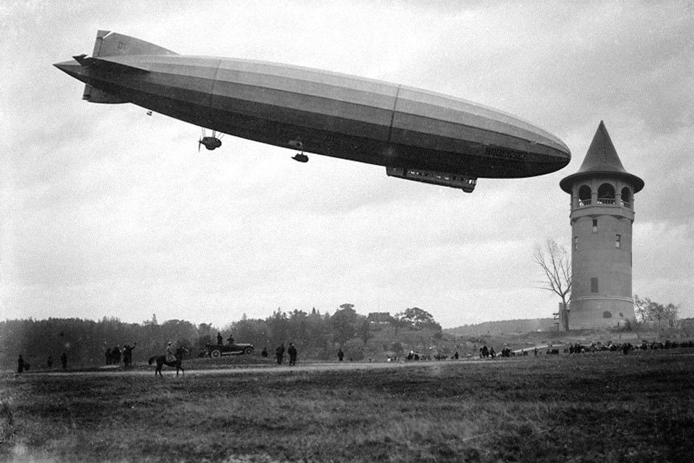 BestPixMN's tweet photo. In 1919, Zeppelin LZ210 "Bodensee" moored atop the Witch's Hat Water Tower to the delight of the assembled citizens of Minneapolis. It was the first and only time the tower was used for its originally designed purpose as a docking station for airships. https://t.co/ULsr7DwDqp