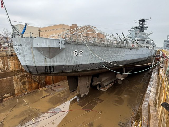 Check out this before and after! Now that the dock is drained, we have begun pressure washing the mud off the hull.