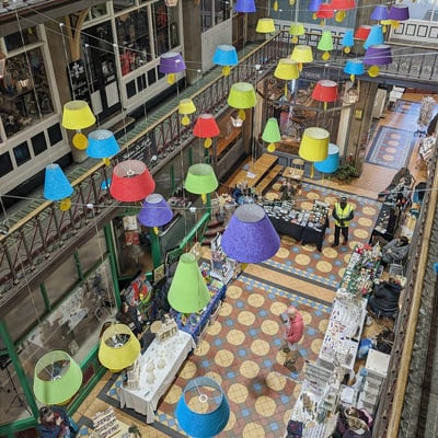 Look at this colorful canopy of lampshades adding a whimsical touch to the eclectic market scene below. #MarketVibes #ColorfulCanopy #ShoppingSplendor 🛍️💡🎨 But where is this?