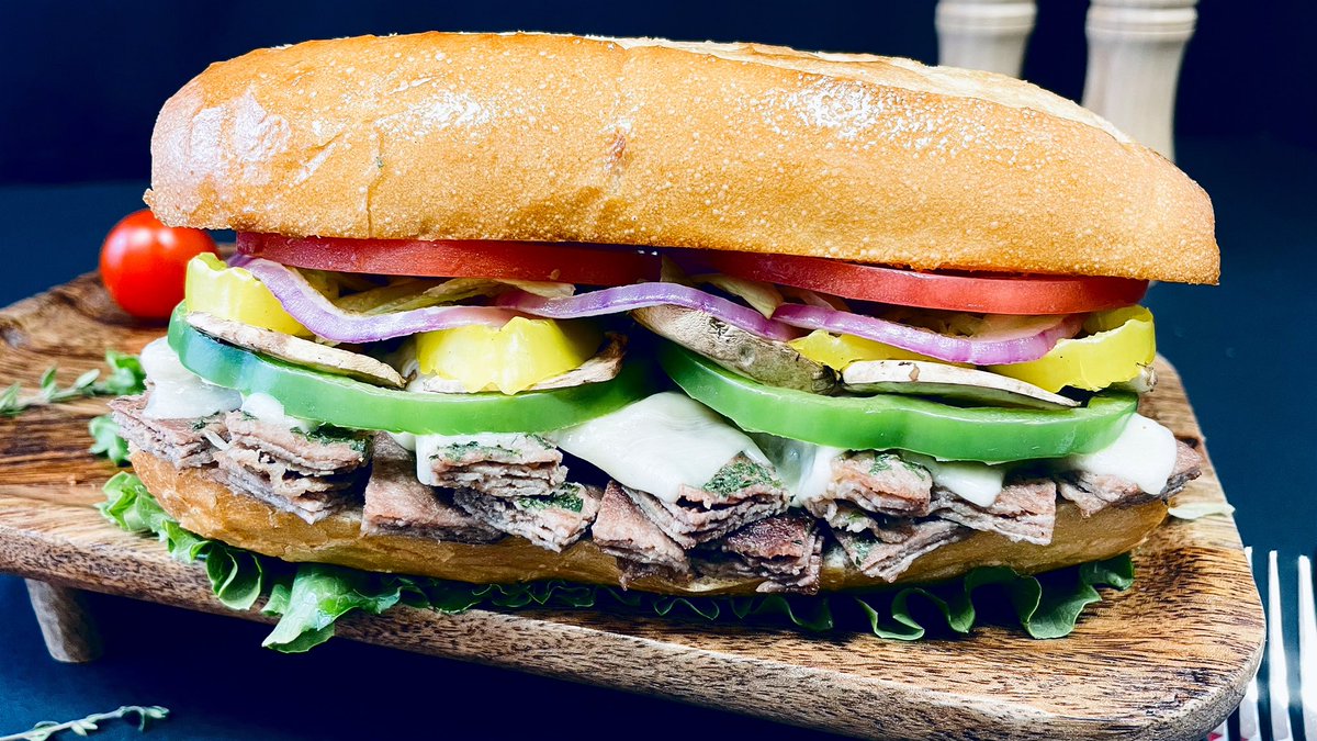 Indulge in the ultimate steak hoagie experience! Our Supreme Steak Hoagie features tender steak, gooey provolone cheese, and a medley of fresh veggies, all topped off with creamy mayo. Satisfaction guaranteed! 🥩🧀🥦 #SteakHoagie #Foodie