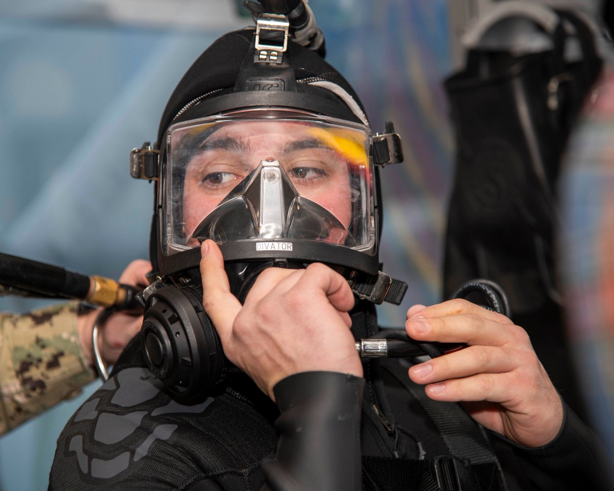 Diver Xavier Framilla tests his mask as he prepares to perform a routine inspection dive on a #nuclearfleet Virginia-class submarine at Portsmouth Naval Shipyard. #maintenancematters #peoplegetthingsdone #teamnavalreactors