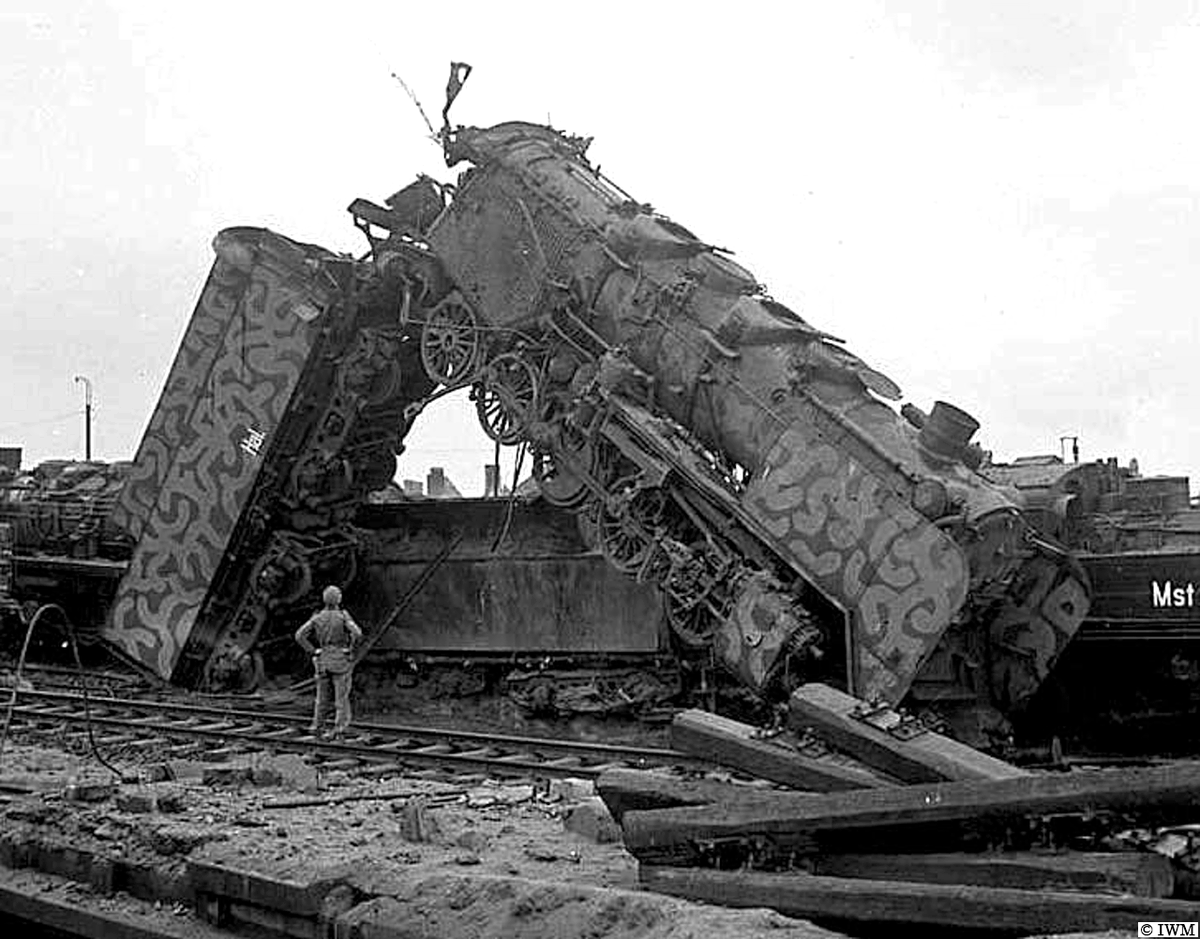 #OTD in 1945, Münster, Germany. A British soldier dwarfed by a German railway locomotive. #WW2 #HISTORY