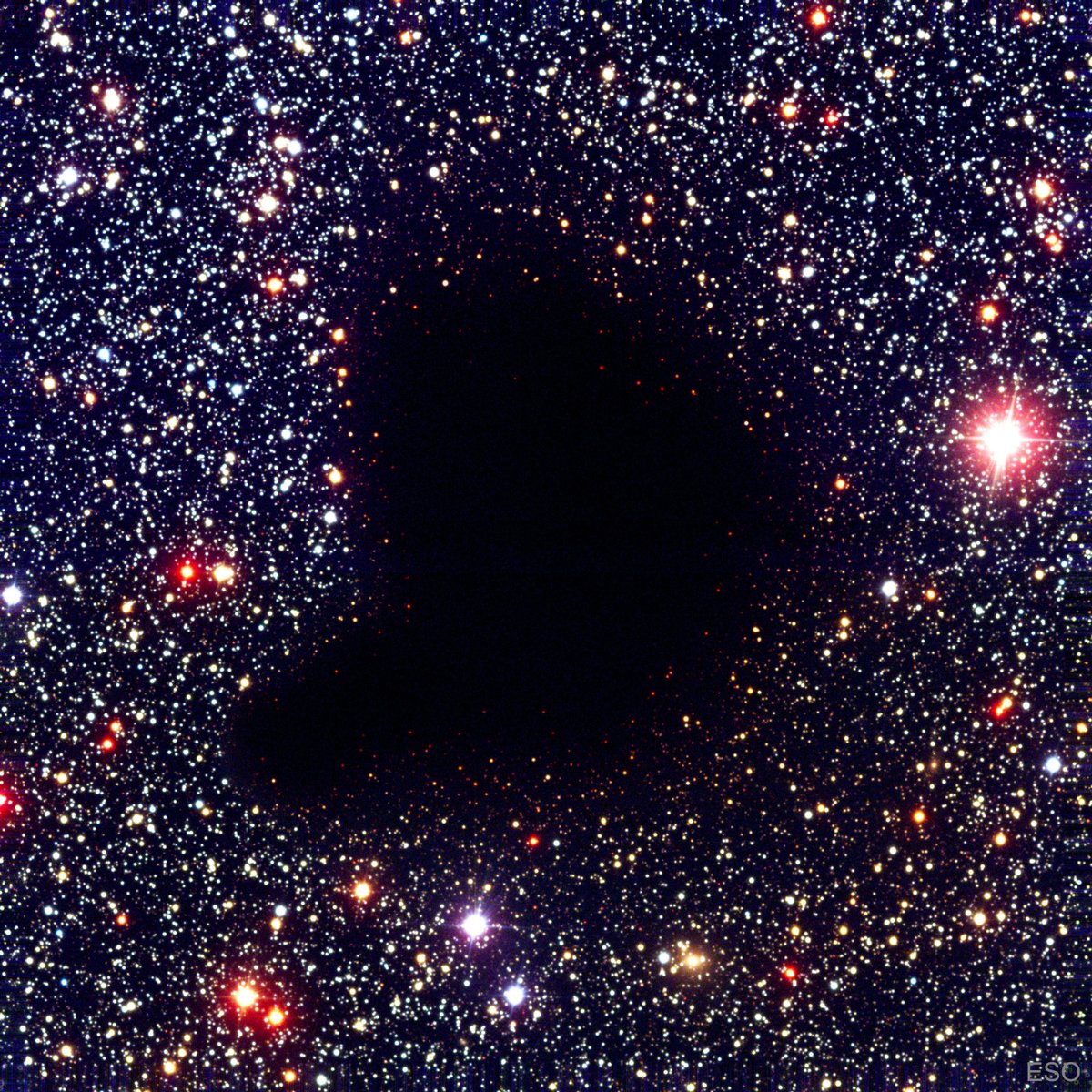 This is Barnard 68, a dark nebula situated in the constellation Ophiuchus. The dust in it is so thick that it blocks the light from the stars behind it.