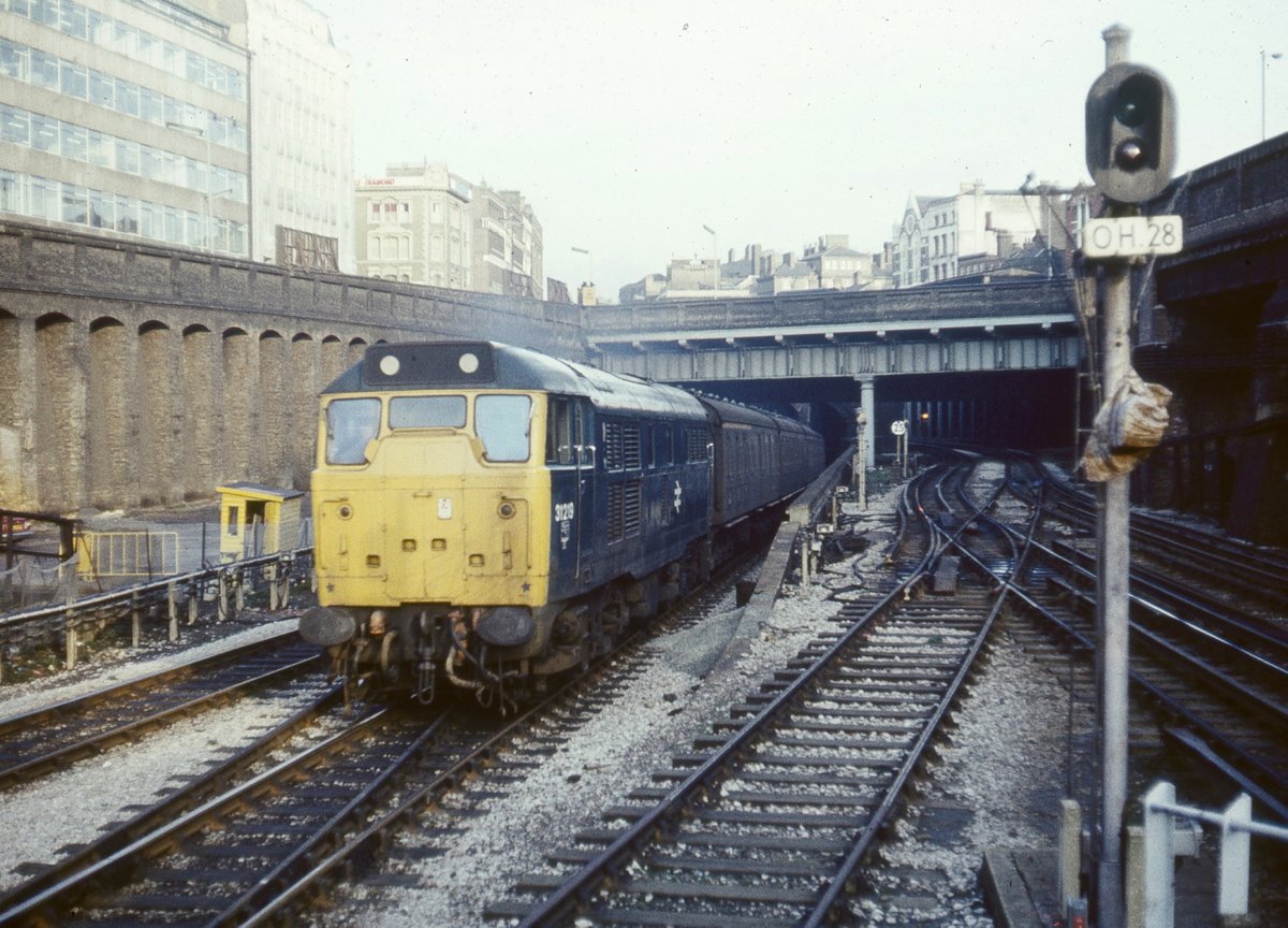 Flashback Friday: Class 31 No. 31219 approaches Farringdon station passing under Clerkenwell Road bridge, with empty stock heading to Moorgate, in March 1977. Today, the platforms are longer and the BR to LT crossover has gone.