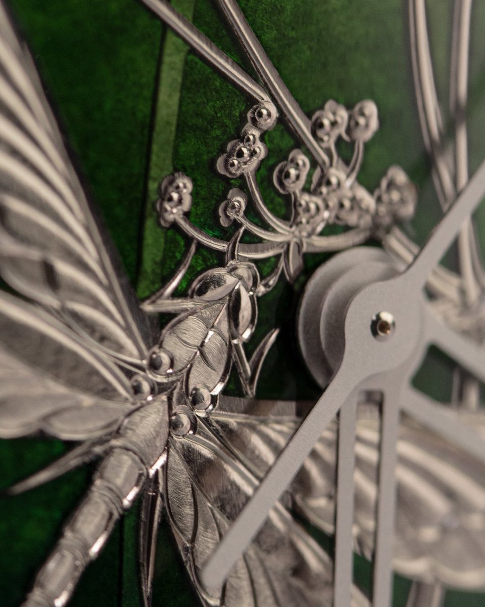 Detail of the damselfly from a unique champlevé enamel dial in solid white gold.