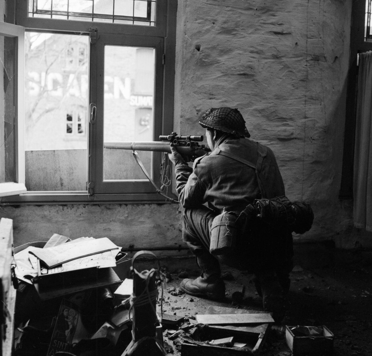 A Scottish sniper from C Company, 5th Battalion, The Black Watch in position in a ruined building in Gennep, the Netherlands, on February 14, 1945. #History #WWII