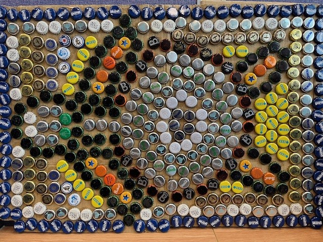 ♻️ Congratulations to Jocelyn Grant who won the Repurposing Packaging Artwork Competition from @kingscardio that challenges people to recycle workplace waste into new products/artworks 🖌️ Jocelyn won with an art piece made from an Amazon box and old bottle tops Check it out ⬇️