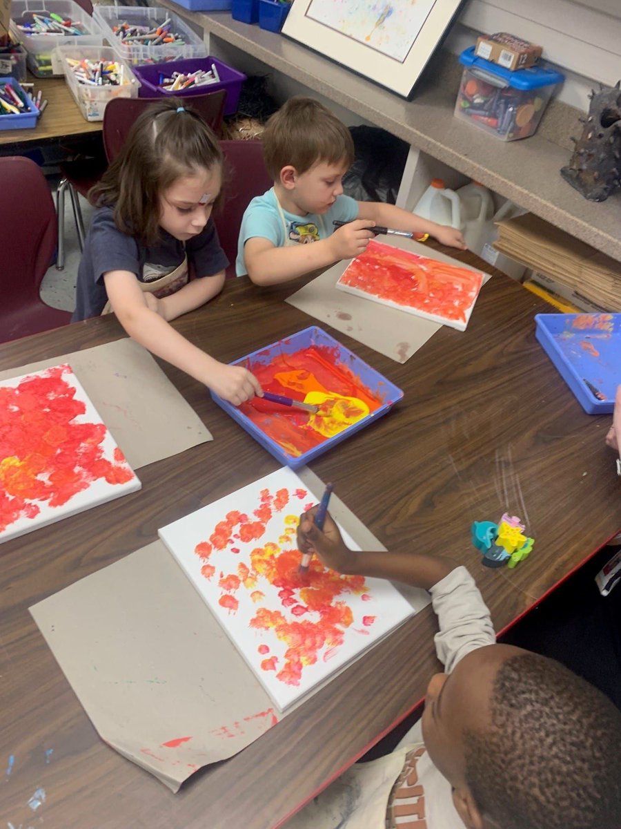 PreK paints on canvases in art!