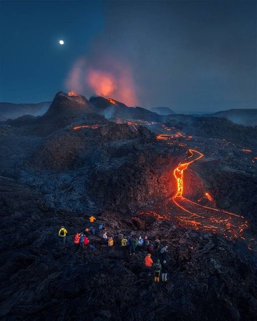 Witnessing the volcano eruption with the moon and the blue hour is something to remember