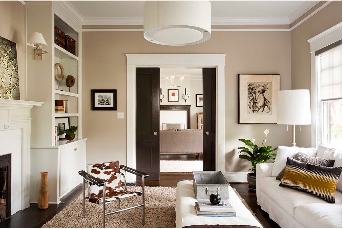 Looking for a beautiful beige paint color? This one can be tricky to use, but when people get it right, it's SO right 👉 bit.ly/3voNGSJ 📸 credits: @e.lynndesign (bookcases) @fallenleafliving (living room) @terracottadesignbuild (living room)