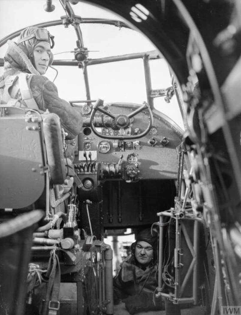 An interior view of the cockpit of an Avro Manchester Mark I of No. 207 Squadron, based at RAF Waddington, Lincolnshire, It shows the captain, Flying Officer P Burton-Giles seated at the controls and the observer or front gunner in the nose section. IWM © image. 🤭