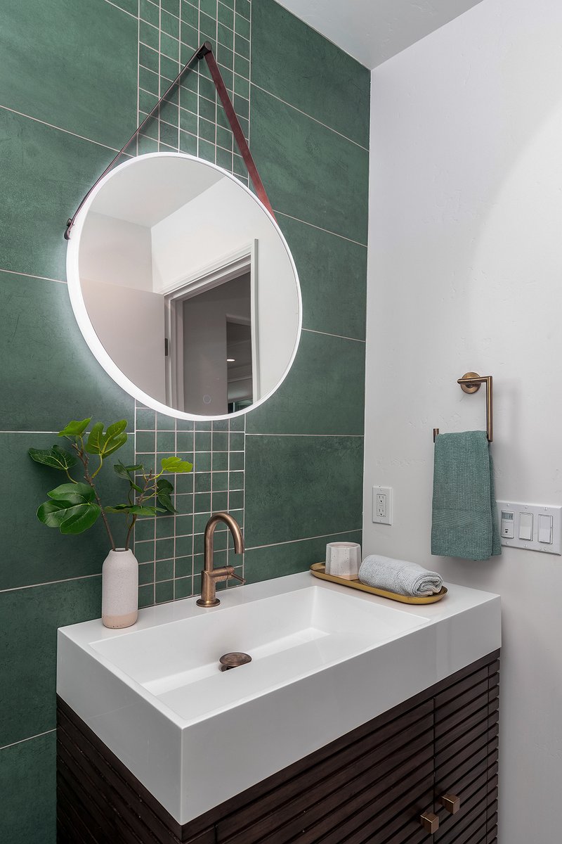 Love the calming sage green and geometric tile design in this pretty powder room.