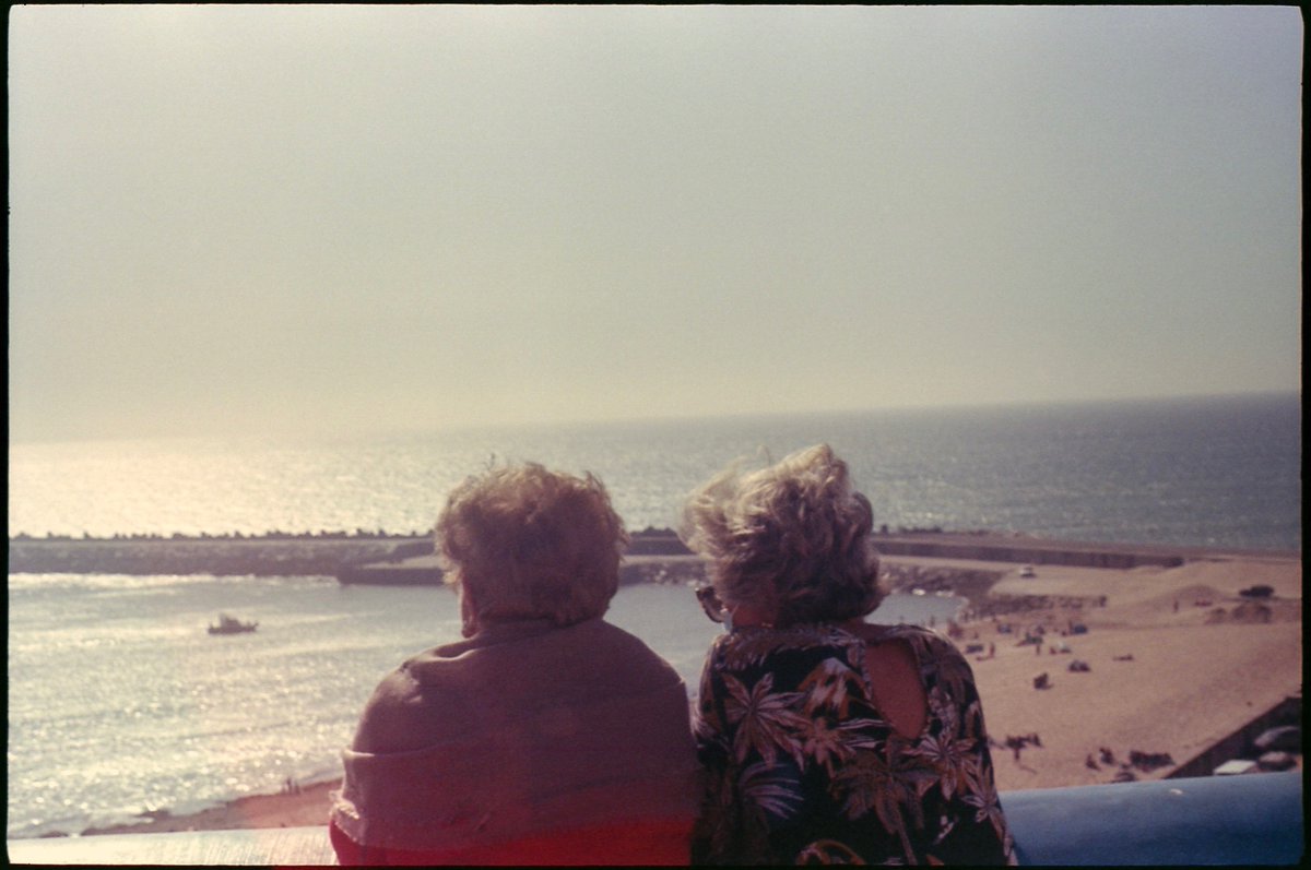 two ladies watching over the sea.