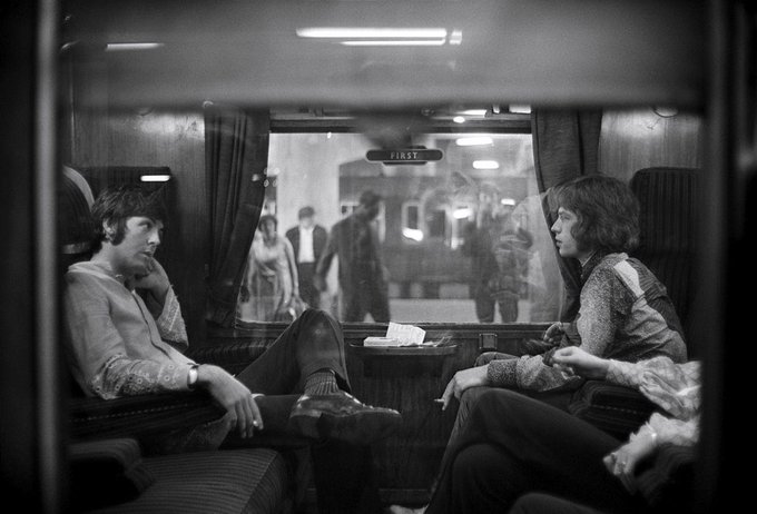 Paul McCartney and Mick Jagger on train to Bangor, Wales, August 1967, Photo by Victor Blackman.