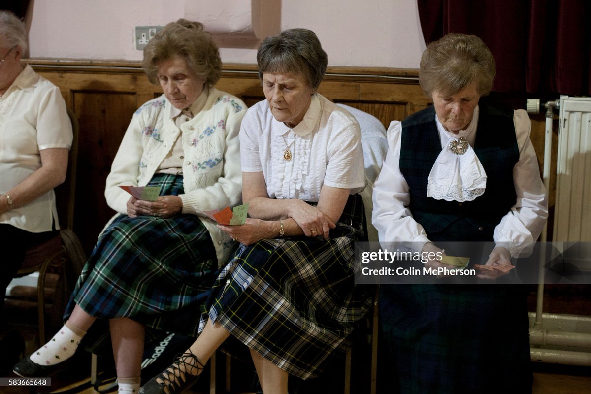 Guests checking raffle tickets at a St. Andrew's dinner dance held by the Sandbach and District Caledonian Society at Sandbach Town Hall, Cheshire, England on St. Andrew's Day (2012)