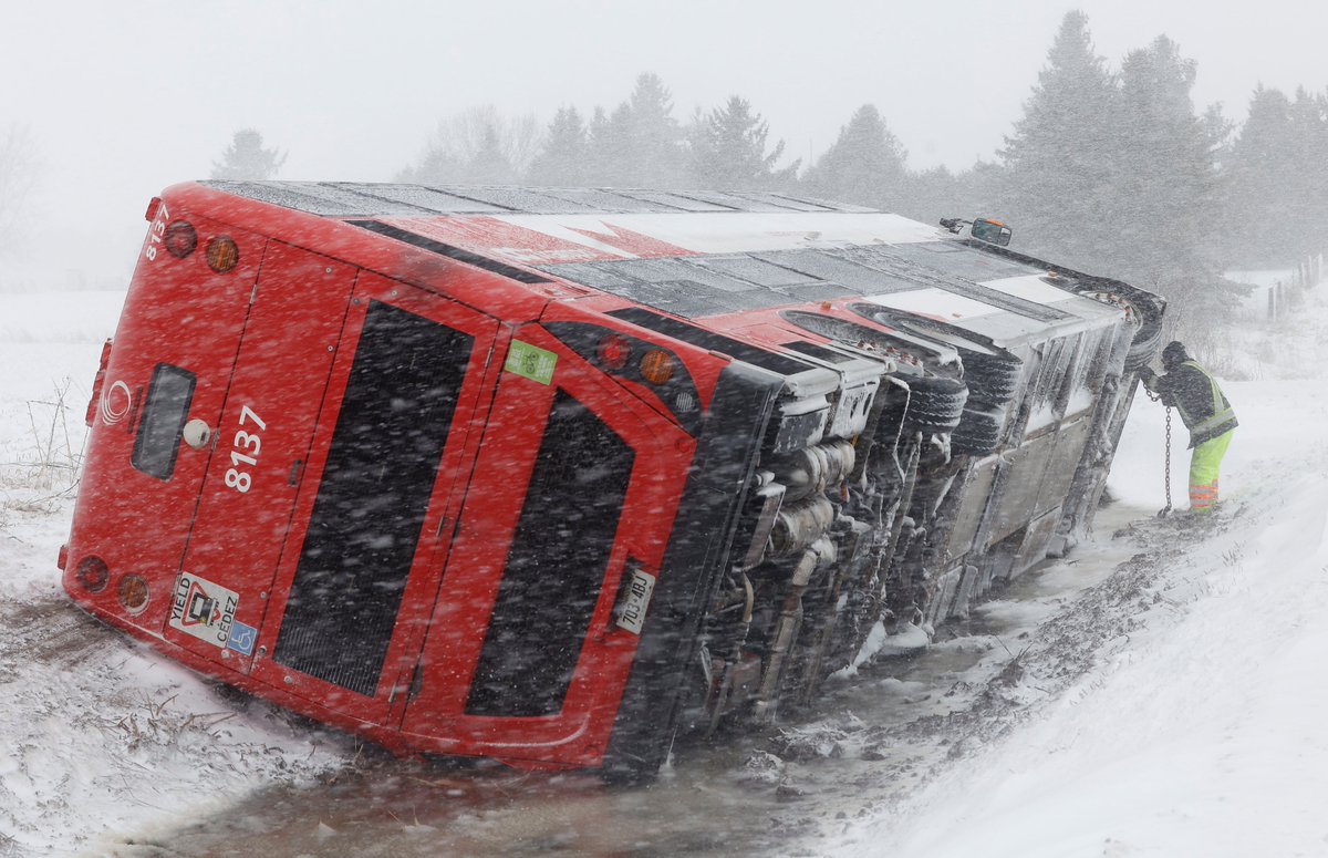 A OC Transpo double decker bus sits on its side in the ditch on Frank Kenny Road in #Ottawa Thursday. An overnight Ottawa snow storm caused havoc on the roads early Thursday morning. #Ottnews #ottweather #weather #springstorm #ONStorm @OttawaCitizen