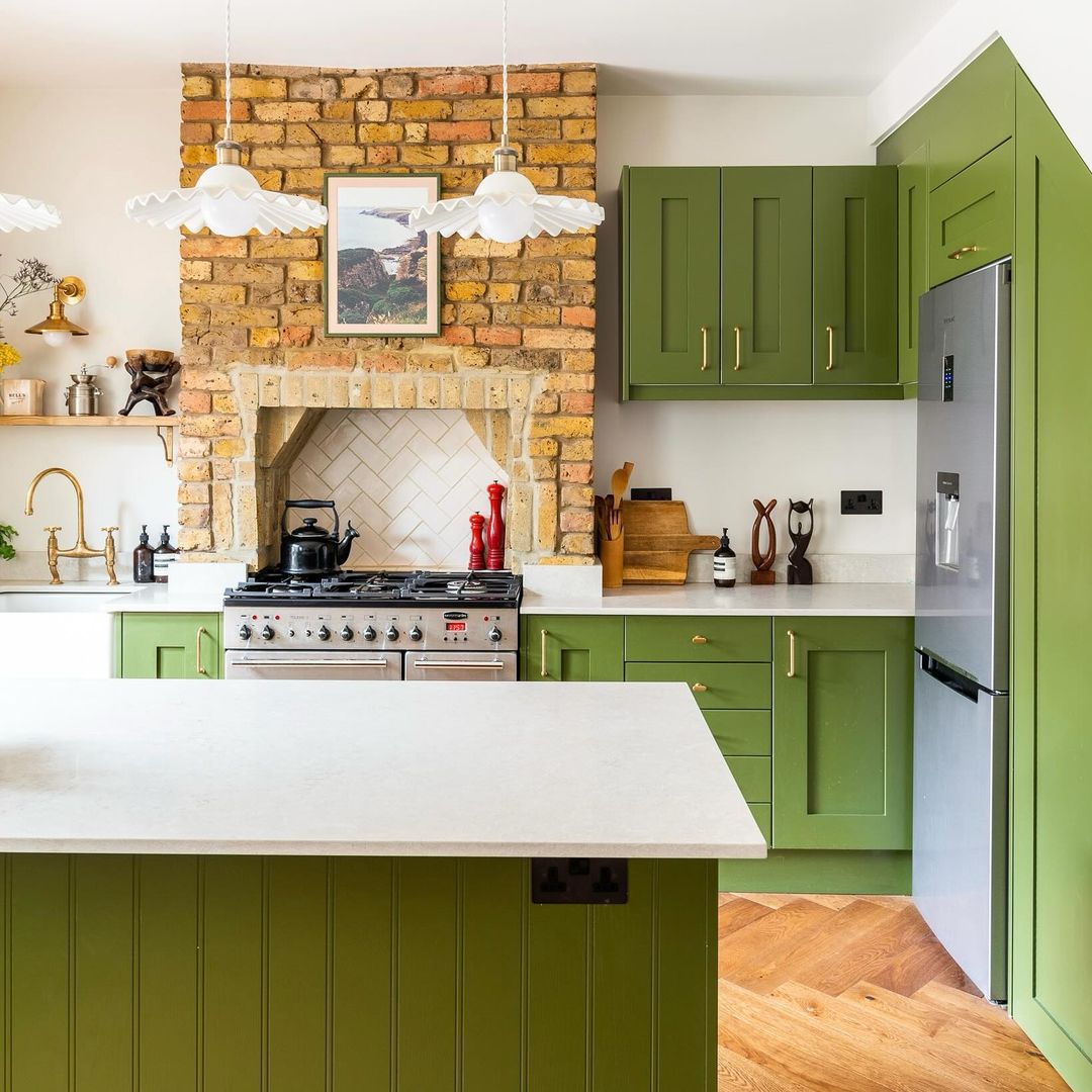 Olive Colour cabinetry, pairs with Portland Stone and Portland Stone - Pale walls in this welcoming kitchen. The exposed brick further enhances the cottage-like charm of the space. Credit: @housebymia