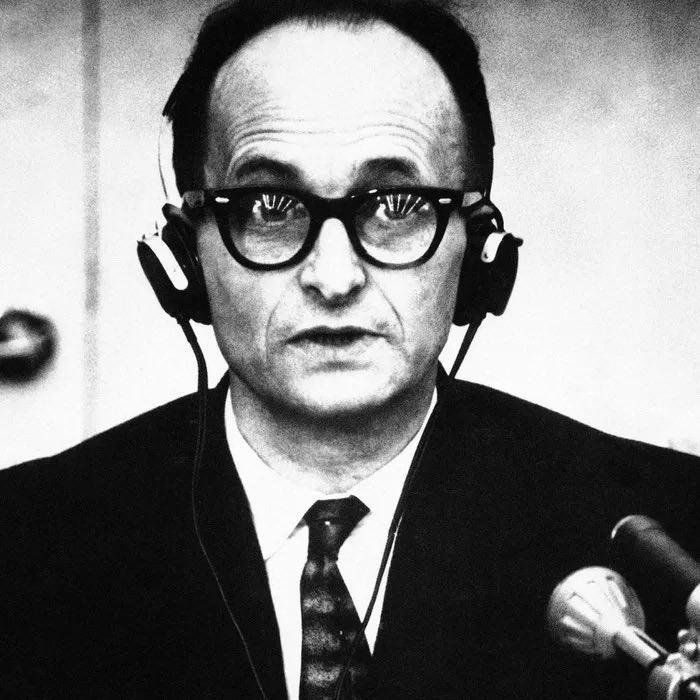 The man in this picture is Adolf Eichmann. He was the Nazi that facilitated and managed the logistics involved in the mass deportation of millions of Jews to Nazi ghettos and Nazi extermination camps across German-occupied Europe  

At the end of World War II, he escaped to