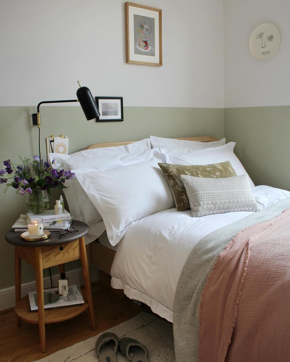 A pale, tonal variant of the popular Green Stone paint shade, Green Stone - Pale imbues a natural softness into the scheme. Applied to the lower half of this wall, it simulates the presence of a headboard, enveloping the bed with a cocooning comfort. Credit: @_millergrey