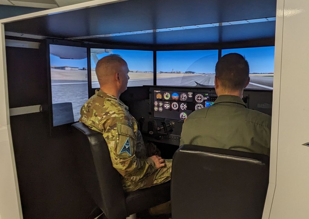 SFJROTC's tweet photo. #GuardianSpiritWeek — leadership team of Space Delta 13 including commander Col. Bryan Dutcher visited #SFJROTC unit at Shadow Mountain HS in Phoenix. He got to try the unit’s flight simulator. Units managed by @HQ_AFJROTC + @SpaceForceDoD @USSF_STARCOM Del13, Det2. https://t.co/NnKOKTDbrR