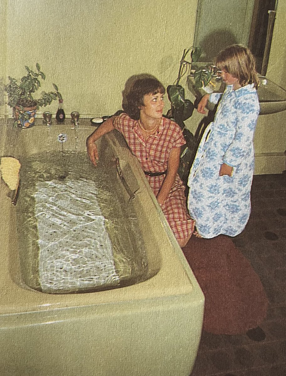 Late 70s Ladybird bathroom picture. Final checks: Avocado suite? ✅ Brown bathroom carpet? ✅ Cheese plant? ✅ Nylon dressing gown?✅ Pageboy haircut? ✅ Good to go.