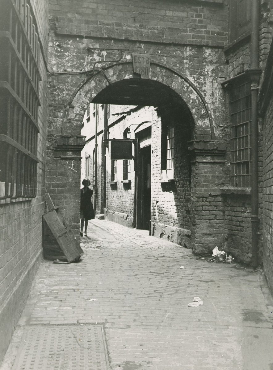 #PhotoFriday. A passageway off Spiceal street near the Bull Ring taken on 26 July 1938. One of many passageways still found in the city centre before WW2. Who’s the figure in the shadows? WK/B11/5418 @LibraryofBham