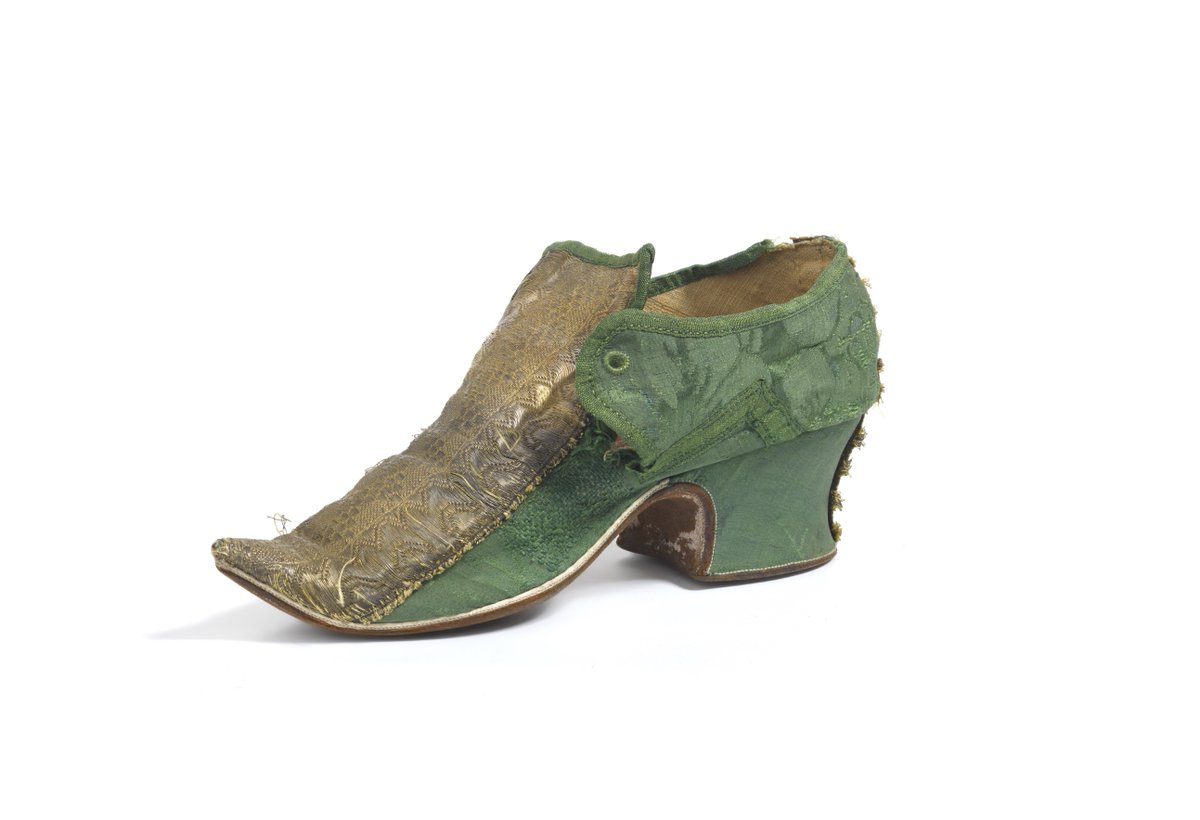 Friday Treat Time and a favourite from the Fashion Museum’s fantastic footwear collection! This green silk damask shoe is decorated with gold braid and dates to the 1730s when women’s shoes were made of fabric and fastened with latchets – or straps – secured with a ribbon tie.