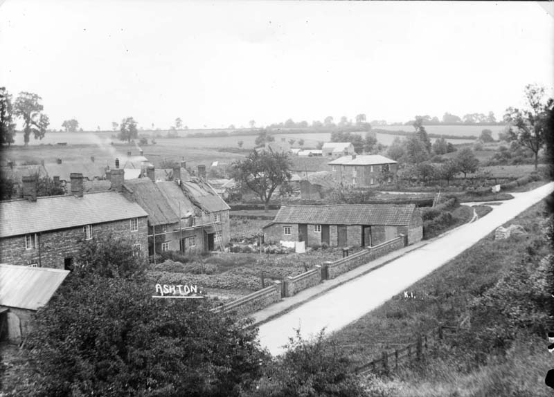 Hartwell Road in Ashton, Northamptonshire. The house in the middle of the picture is being re-thatched. From the glass plate negative collection of Maurice Kitchener. Copyright of the Kitchener Family. Discover more here: bit.ly/KitchenerCDC 📷 KIT/1/120