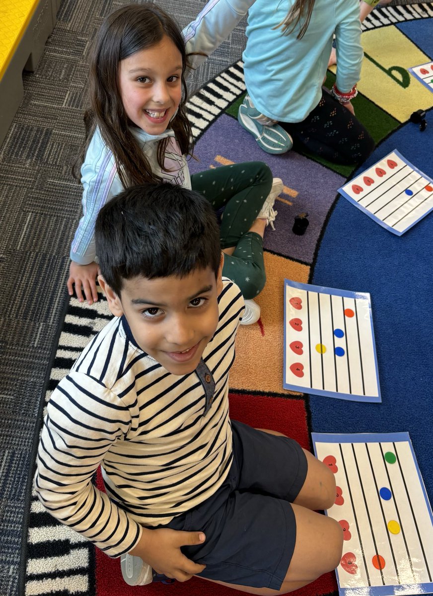 The first graders are exploring the music staff and using bingo chips as note heads. Great work young musicians!!!