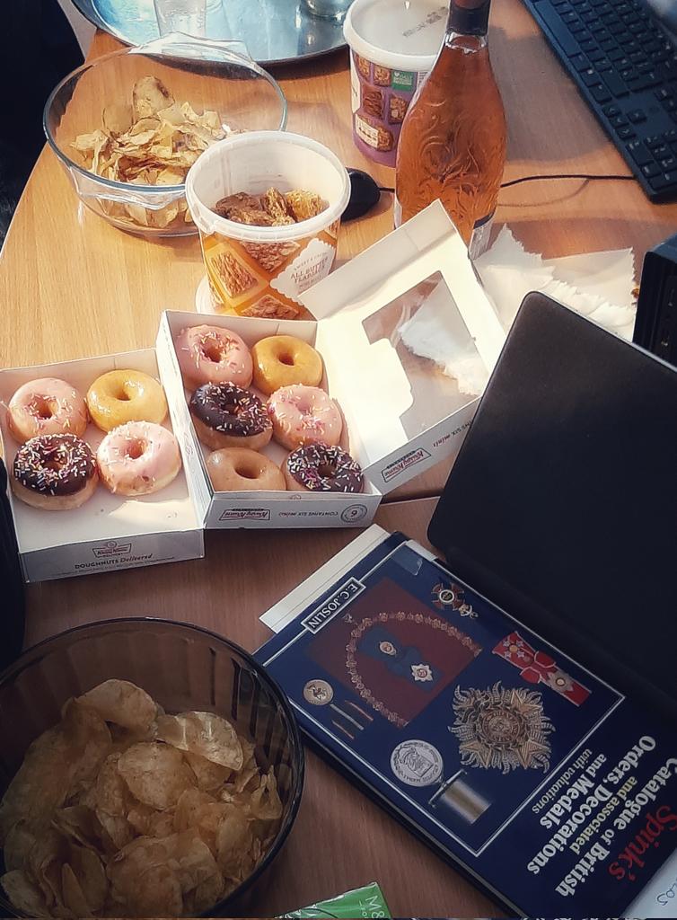 Party in the curators' office. Doughnuts, crisps, Spink's orders, decorations and medals