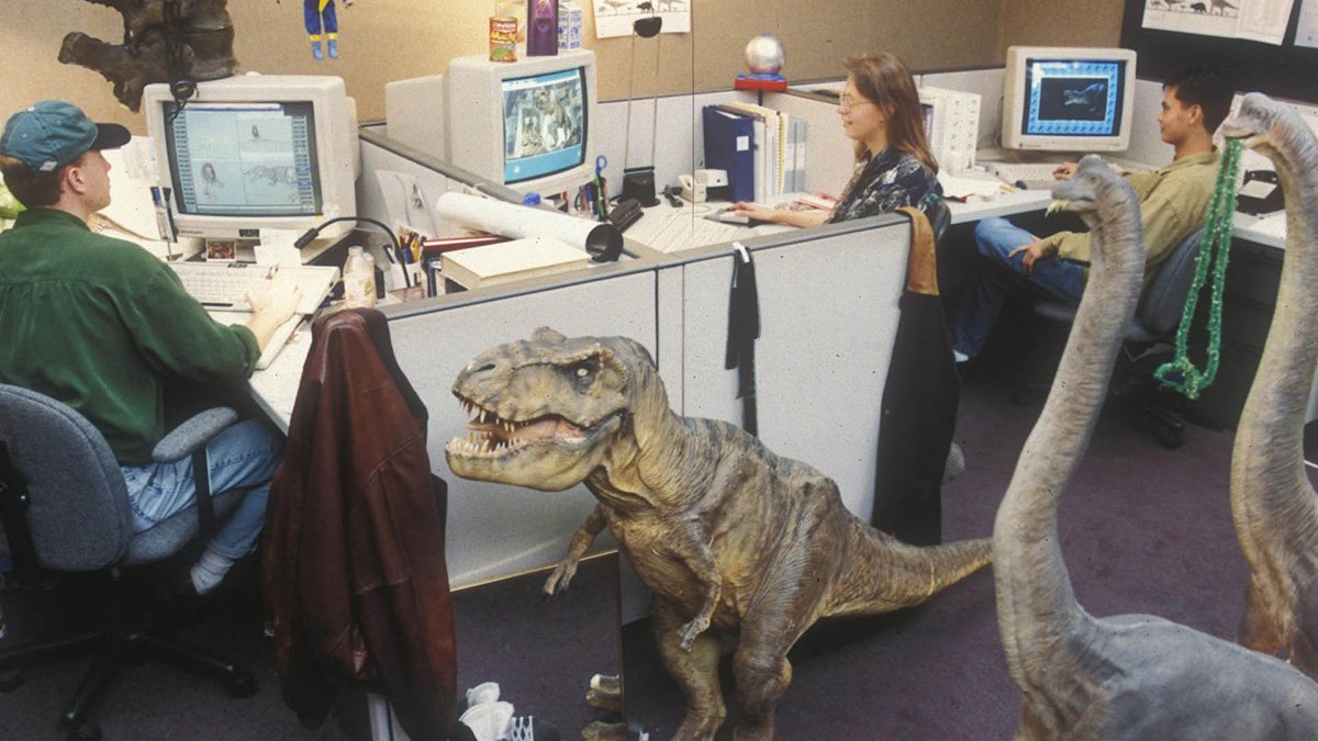 Photo of ILM artists working on the textures for the CGI dinosaurs in Jurassic Park, with the Stan Winston Studio maquettes on hand for reference.