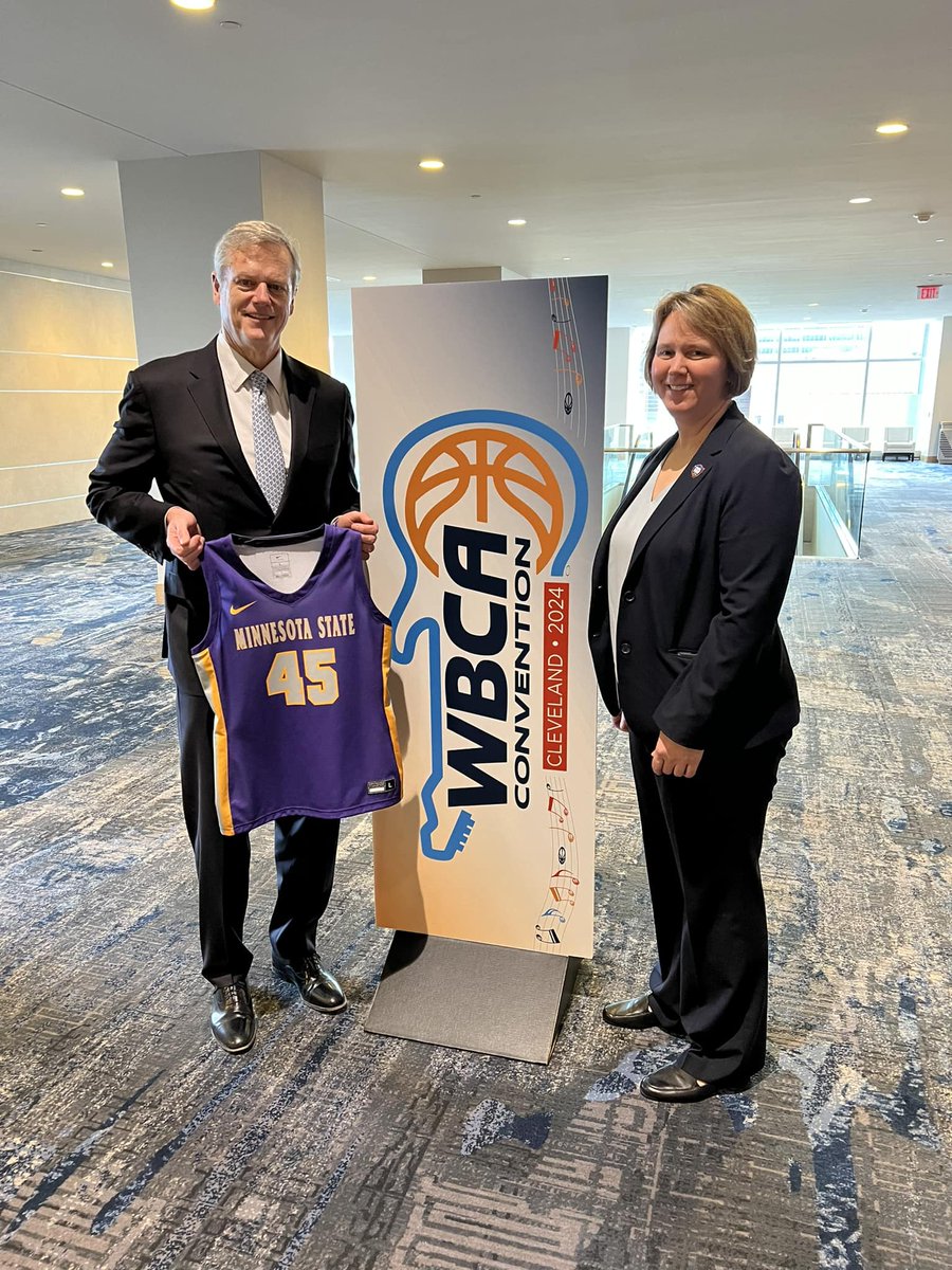 NCAA President @CharlieBakerMA and NCAA Vice President for Women’s Basketball Lynn Holzman pose with a Maverick jersey in advance of today’s WBCA meetings in Cleveland.