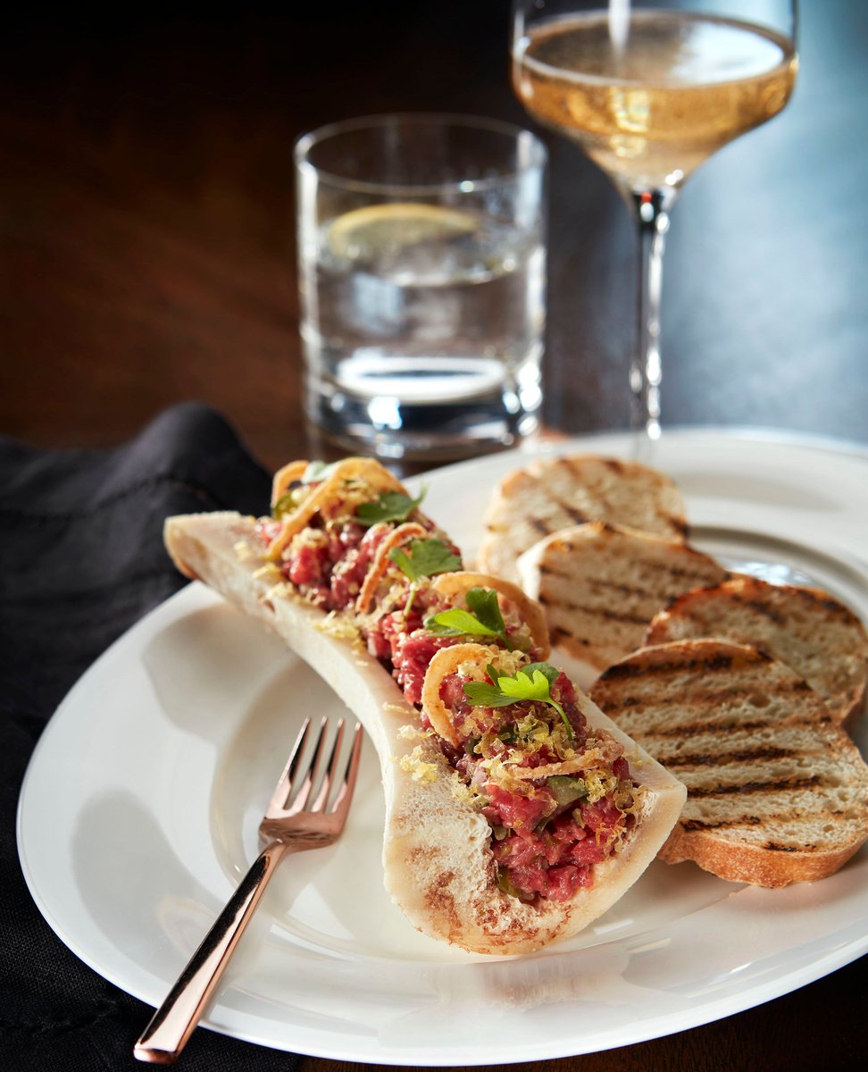 Experience our prime steak tartare, nestled in a decadent bone marrow canoe, offering a delightful contrast of textures, accompanied with pickles and toasted sourdough, at Blueblood Steakhouse. Reservations at BlueBloodSteakhouse.com

#casaloma #casalomatoronto #libertygroup