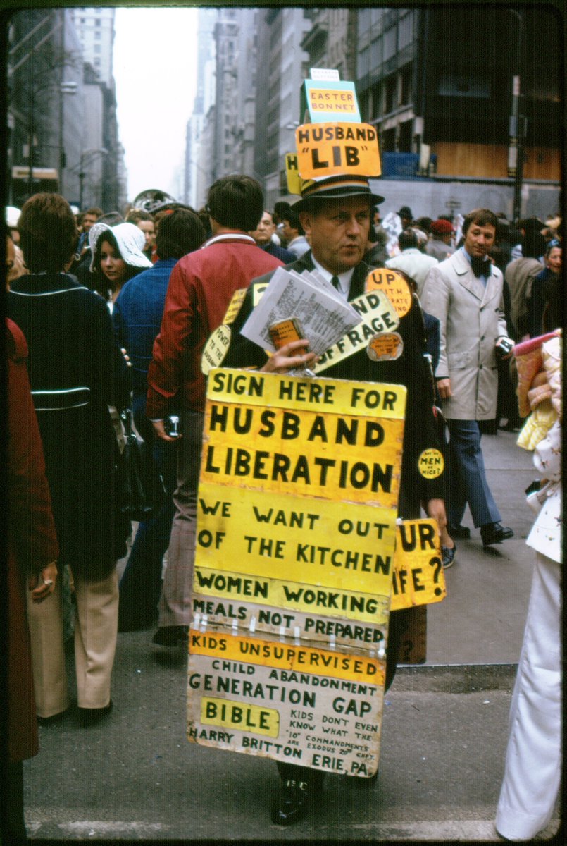 Fifth Avenue, NYC 1974. Photographer unknown. Kodachrome my collection. Harry Britton worked at GE in PA until he got laid off, protested his layoff there until his wife had him committed. He escaped from the hospital and started his 'Husband Liberation' street campaign in NYC.