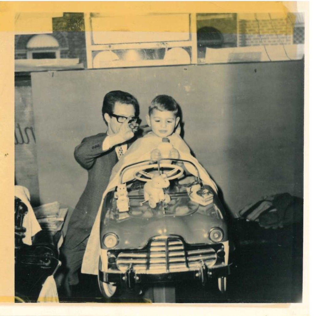 What object from our collection has an interesting story? This pedal car dates from the early 1950s and was used as a child’s seat in salons. You can see a young boy in the car at Eileen & Bernards in Prestwich in ca. 1960. It was lasted used in Bernards in Swinton in 2003.