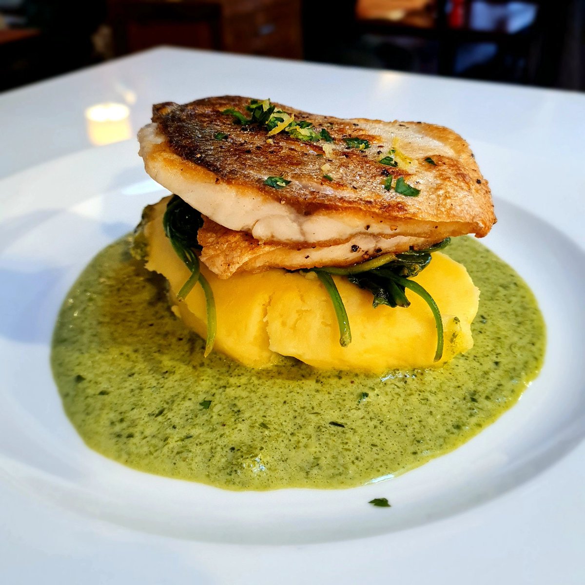 Pan-fried fillet of sea bass with a delicious wild garlic velouté on our menu now Thanks to Richard for letting us photograph his order, the first of the evening! #seabass #bass #fish #wildgarlic #fishsupper #FishFriday