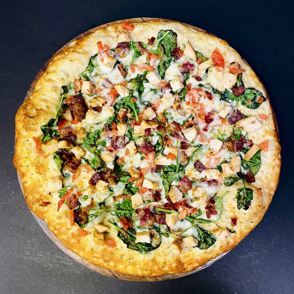 Savor the perfect blend of flavors with our Spinach and Chicken Pizza! Bursting with tender chicken, fresh spinach,  crunchy bacon and melted cheese, it’s a taste sensation you won’t soon forget. 🍕 #PizzaDelight #GourmetTreat