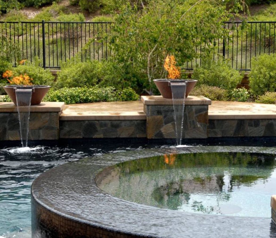 Looking for warmth and beauty? Add an outdoor fireplace or fire pit! Stone, tile, and brick options abound. Need help deciding? Contact Infinite Pools at 951-354-9888 or visit infinitepools.com. We'll make your yard dreams come true! 🏡✨#OutdoorLiving #Fireplace #FirePit
